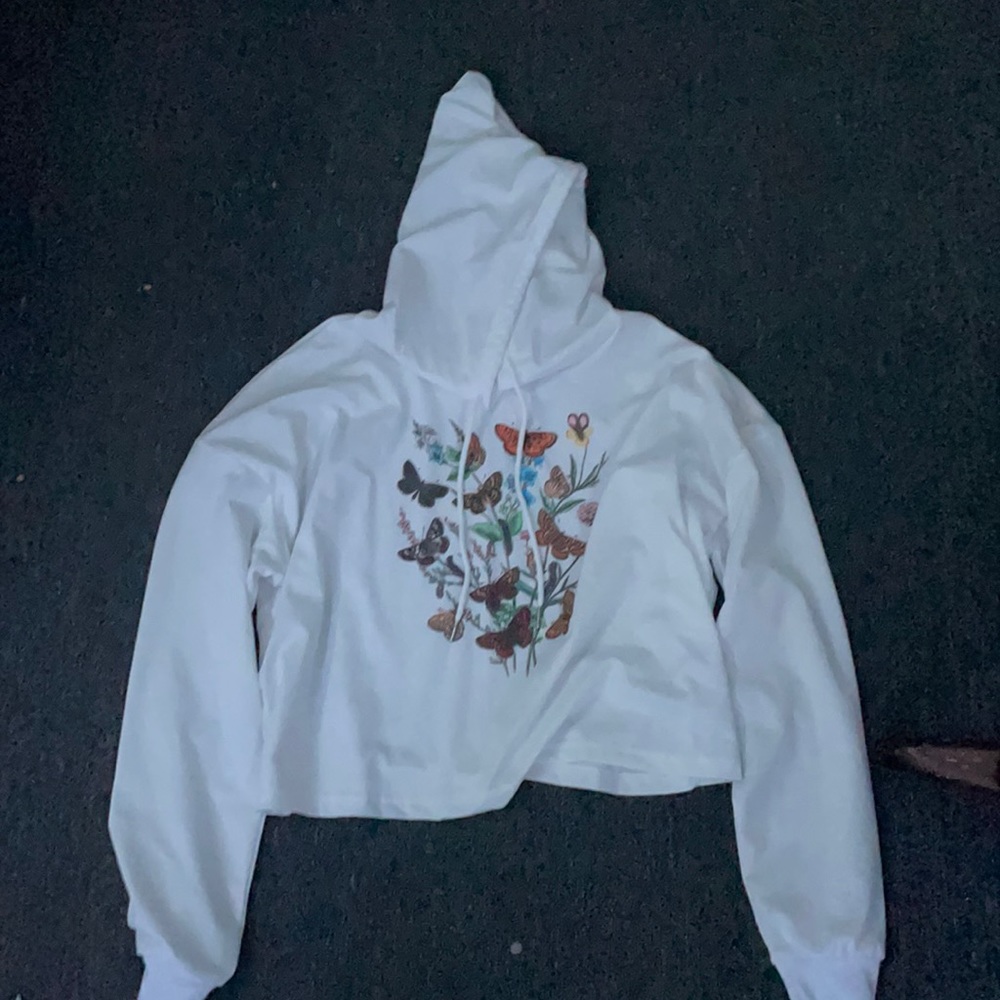 A white hoodie crop top with butterflies